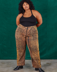 Morgan is 5'5" and wearing 2XL Leopard Work Pants and black Halter Top