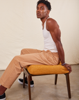Jerrod is wearing Long Work Pants in tan and wearing paired with Tank Top in vintage tee off-white