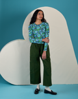 Shahana is wearing Long Sleeve Baby Tee in Angel Print paired with evergreen Drop Pocket Cargo Pants