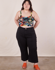 Ashley is wearing Cropped Cami in Rainbow Magic Waters paired with black Petite Western Pants