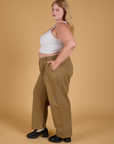 Side view of Baggy Mid-Rise Trousers in Desert Brown and vintage tee white Cropped Tank on Juliet