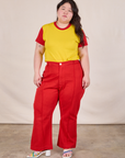 Ashley is wearing Mismatched Tee in Yellow & Red and mustang red Western Pants