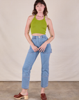 Alex is wearing Halter Top in Gross Green and light wash Carpenter Jeans
