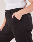 Organic Work Pants in Basic Black side close up. Ryan has her hand in the pocket.