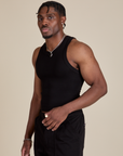 Racerback Tank in Black angled front view on Isaac