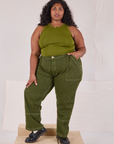 Morgan is 5’5’” and wearing 2XL Railroad Carpenter Jeans in Summer Olive and summer olive Muscle Tee