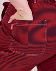 Close up of Ashley's hand in the back pocket of Railroad Carpenter Shorts in Mustang Red