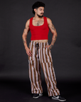 Jesse is 5'8" and wearing S Striped Drop Pocket Pants in Retro Rainbow paired with a mustang red Cropped Tank