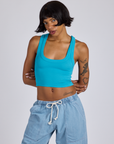 Kira is 5’10” and wearing P Cropped Tank Top in Hawaiian Blue