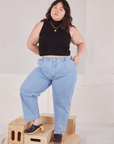 Ashley is wearing Sleeveless Essential Turtleneck in Basic Black and light wash denim Trouser Jeans