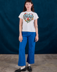 Alex is wearing Chicago Tourist Tee and royal blue Western Pants