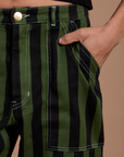 Close up of Anthony's hand in the front pocket of Black Stripe Work Pants in Evergreen