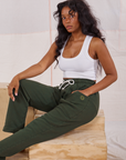 Kandia is wearing Rolled Cuff Sweat Pants in Swamp Green and vintage off-white Cropped Tank