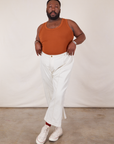 Elijah is wearing Tank Top in Burnt Terracotta tucked into vintage tee off-white Western Pants