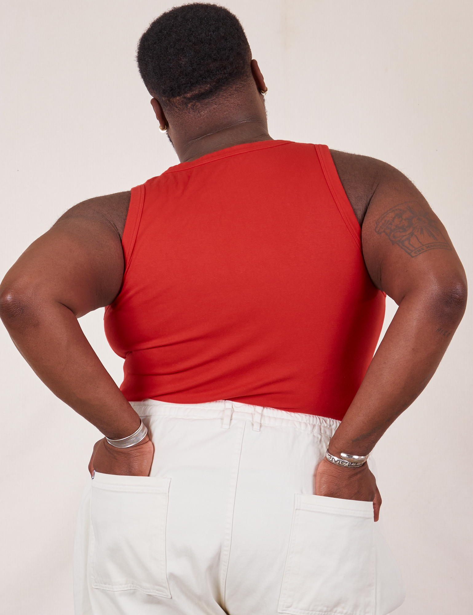 Back view of Tank Top in Mustang Red and vintage tee off-white Western Pants on Elijah