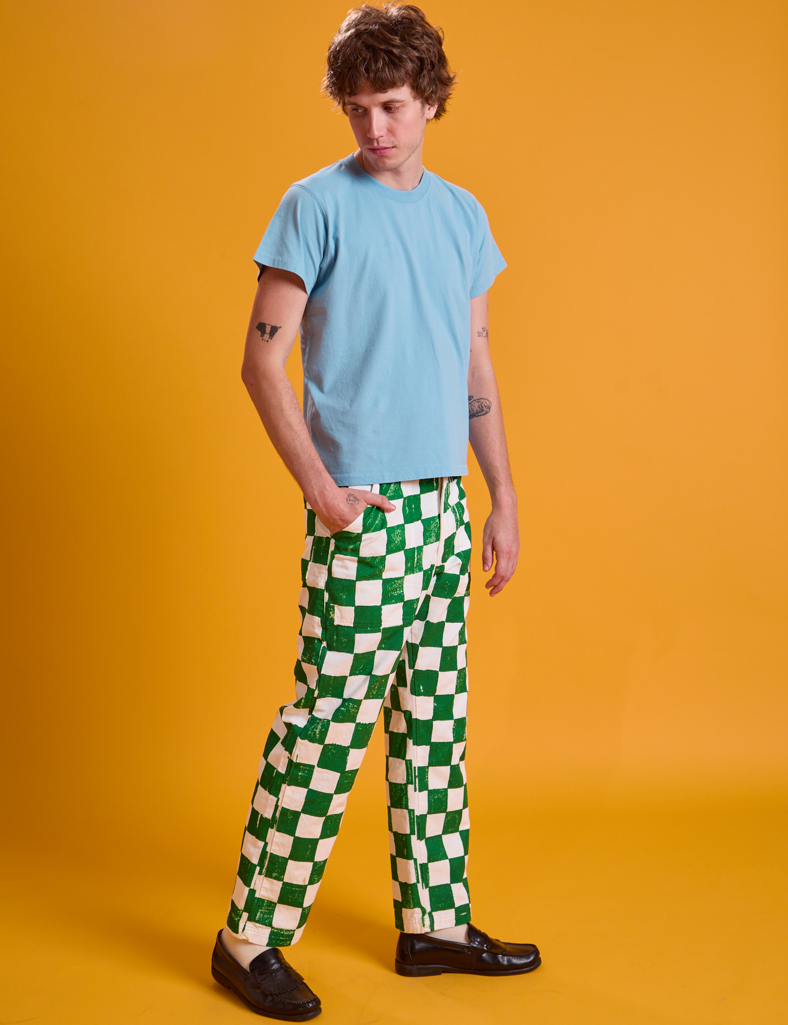 Side view of Checkerboard Work Pants in White/Green and baby blue Organic Vintage Tee on Quinn