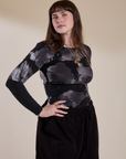 Angled front view of Long Sleeve Baby Tee in Ink Blot on Sydney