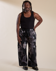 Demi is 5'6" and wearing S Magic Waters Drop Pocket Pants in Ink Blot paired with black Cropped Tank