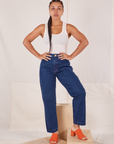 Gabi is 5'7" and wearing XXS Denim Trouser Jeans in Dark Wash paired with Tank Top in vintage tee off-white