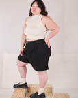 Side view of Trouser Shorts in Basic Black and Sleeveless Turtleneck in vintage tee off-white on Ashley