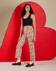 Angled front view of Work Pants in Hot Stuff Print and black Cropped Tank on Shahana