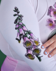Close up of screen-print flower on sleeves of Floral Long Sleeve Baby Tee in Pink