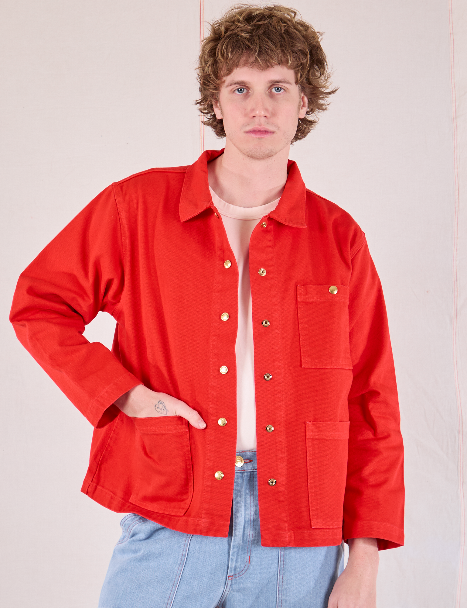 Quinn is 6'4" and wearing L Denim Work Jacket in Mustang Red