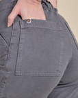 Close up of Alex's hand in the back pocket of Work Pants in Washed Grey