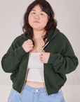 Ashley is wearing Cropped Zip Hoodie in Swamp Green with a vintage off-white Cropped Tank underneath