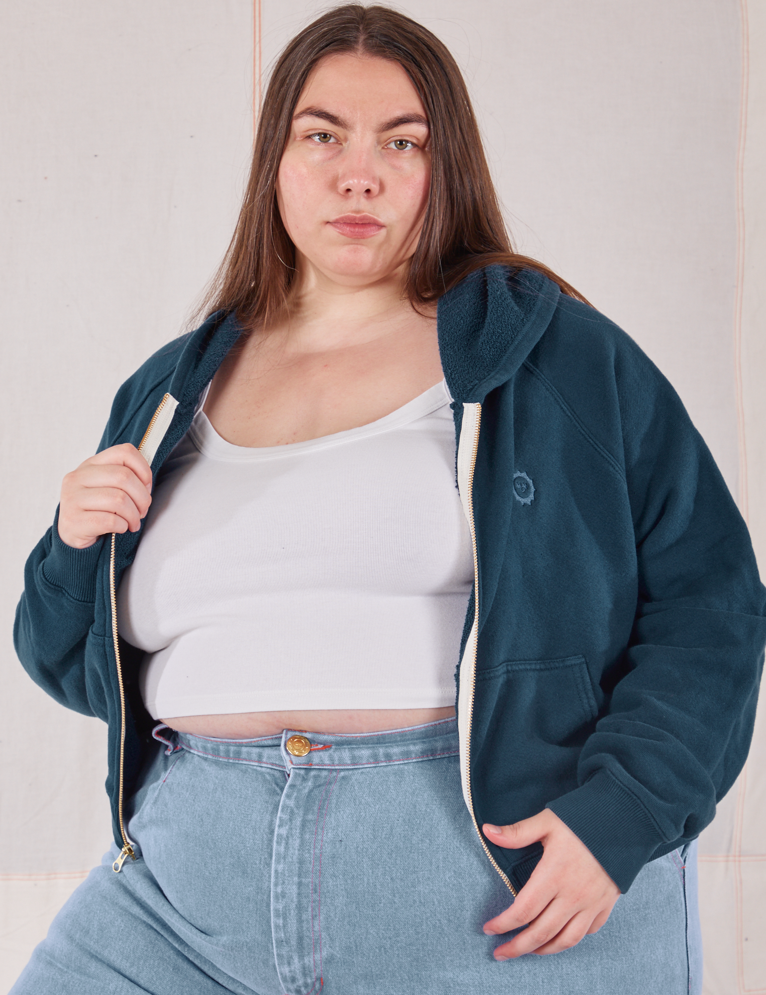 Marielena is wearing Cropped Zip Hoodie in Lagoon and a vintage off-white Cropped Tank