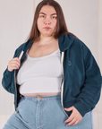Marielena is wearing Cropped Zip Hoodie in Lagoon and a vintage off-white Cropped Tank