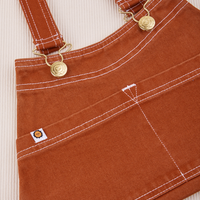 Overall Handbag in Burnt Terracotta. Contrast white stitching. Brass sun baby buttons and hardware