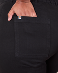 Close up of Morgan's hand in the back pocket of Western Pants in Basic Black