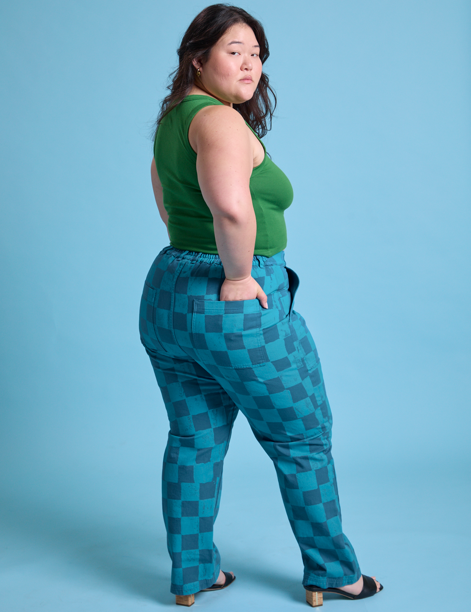 Angled back view of Checkerboard Work Pants in Blues and lawn green Cropped Tank on Ashley