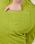 Close up of Ashley's hand in the back pocket of Classic Work Shorts in Gross Green