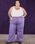 Sam is wearing Overdyed Wide Leg Trousers in Faded Grape and Tank Top in vintage tee off-white