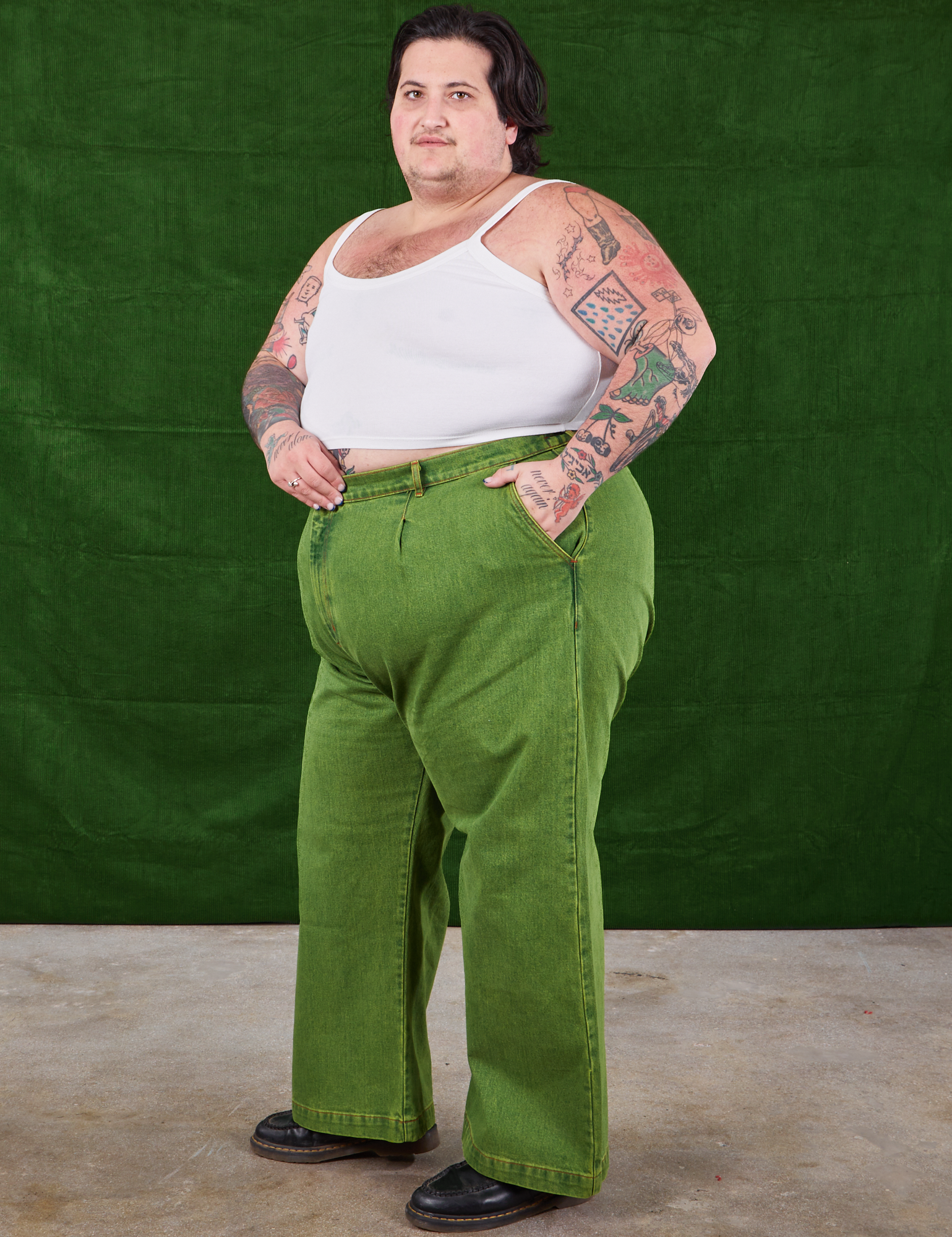 Angled view of Overdyed Wide Leg Trousers in Gross Green and vintage off-white Cami worn by Sam