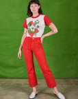 Alex is wearing Anniversary Tee in Strawbaby and mustang red Work Pants
