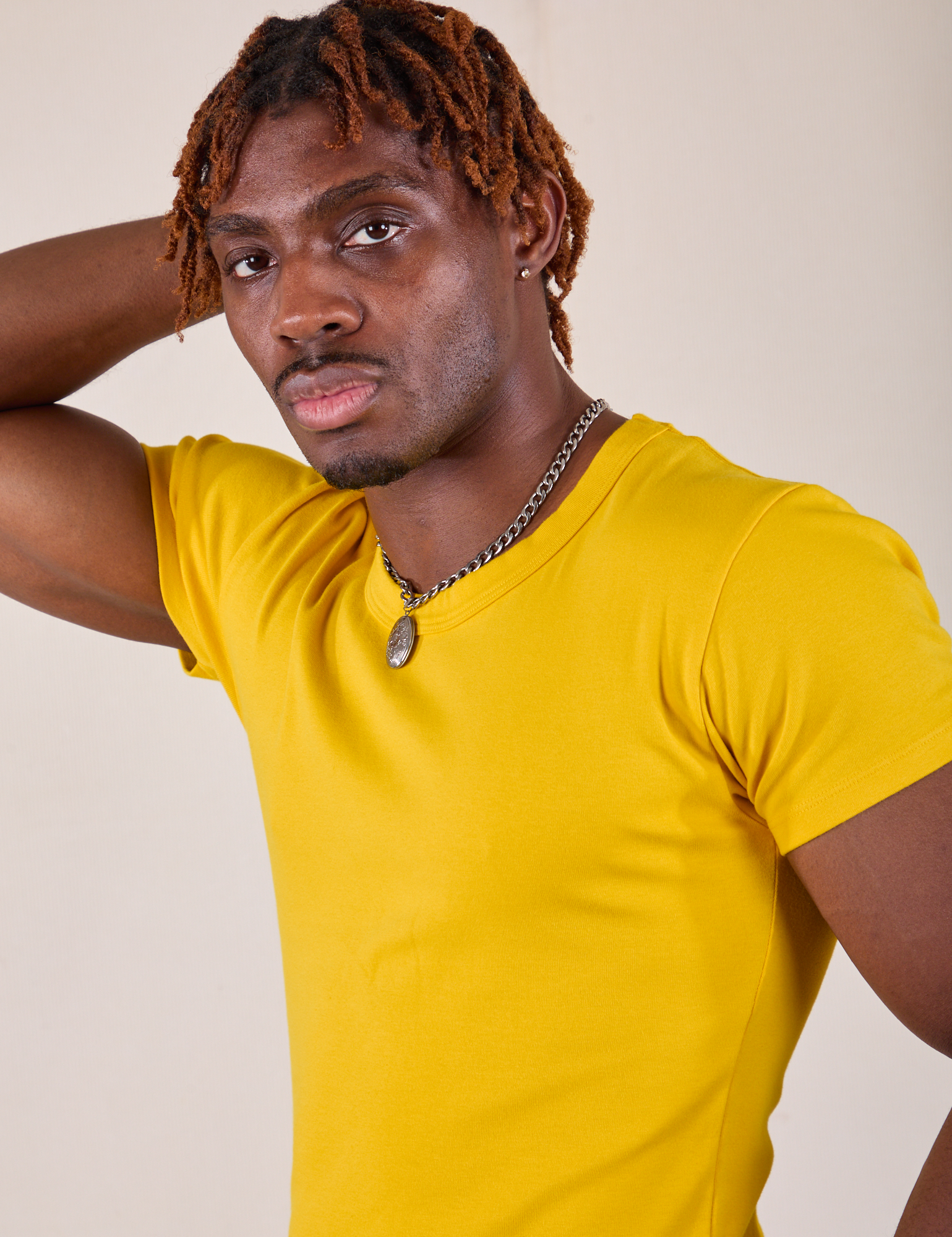 Baby Tee in Golden Yellow angled close up on Isaac