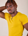 Baby Tee in Golden Yellow angled close up on Isaac