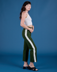 Side view of Painted Work Pants in Evergreen and vintage tee white Cropped Tank