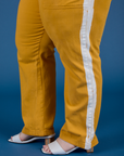 Painted Work Pants in Mustard Yellow pant leg side view close up on Ashley