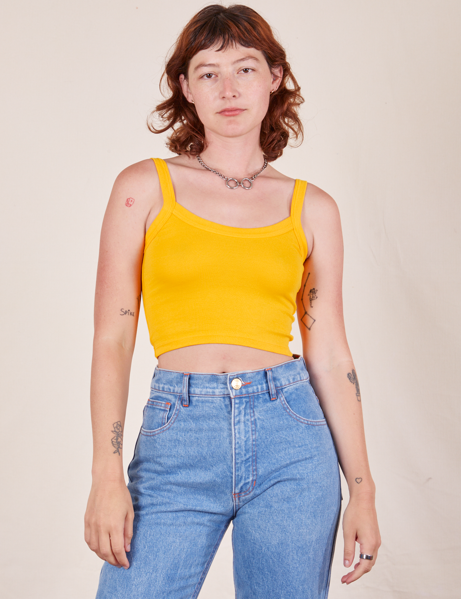 Alex is 5&#39;8&quot; and wearing P Cropped Cami in Sunshine Yellow paired with light wash Frontier Jeans