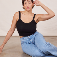 Tiara is sitting on the floor wearing Cami in basic black and light wash Sailor Jeans