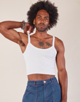 Jerrod is 6’3” and wearing S Cropped Cami in Vintage Tee Off-White paired with dark wash Carpenter Jeans