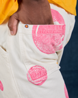 Close up of Isaac's hand in the back pocket of Paintstamped Work Pants in Bubblegum