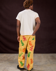 Back view of Gummy Bear Paintstamped Work Pants in Butter Yellow and Organic Vintage Tee in Vintage Off-White