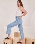 Side view of Carpenter Jeans in Light Wash and vintage off-white Tank Top worn by Allison