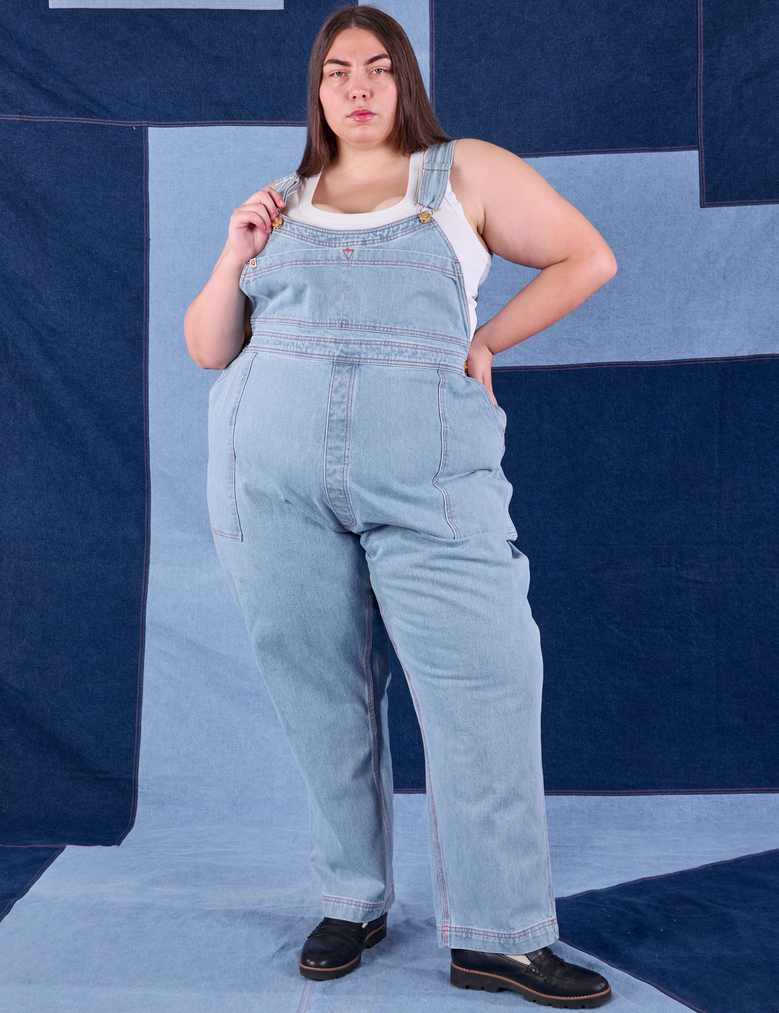 Marielena is 5'8" and wearing 2XL Indigo Denim Original Overalls in Light Wash