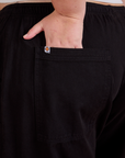 Close up of Juliet's hand in the back pocket of Drop Pocket Cargo Pants in Basic Black